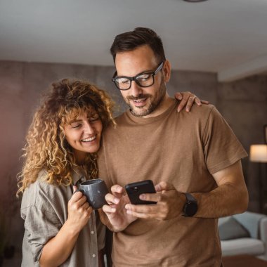 Yetişkin çift portresi. Karı koca cep telefonu kullanıyor.