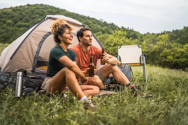 stock image Happy couple camp and drink beer have a fun together time