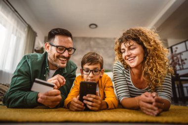 Anne, baba ve oğul internet üzerinden kredi kartıyla alışveriş yapıyorlar.