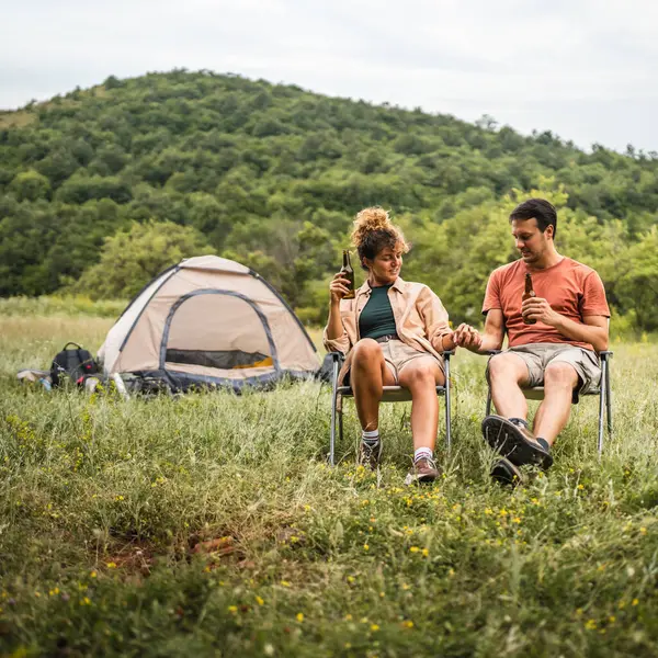 stock image Happy couple camp and drink beer have a fun together time