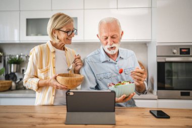 Üst düzey çiftler birlikte kahvaltı eder ve dijital tablet sabah rutini kullanırlar.