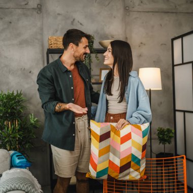 Yetişkin çiftler öpüşür ve evde birlikte ev işleri yaparlar.