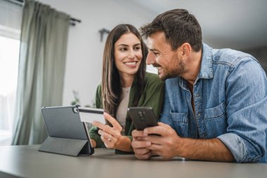 Sevgilisi kredi kartını tutarken, erkek arkadaşı cep telefonundan satın alıyor.
