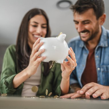 Yetişkin çift evdeki kumbarada para biriktiriyor.