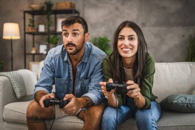 Girlfriend win her boyfriend in video game competition at home clipart