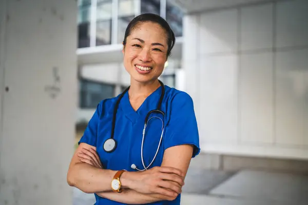 stock image Portrait of mature japanese doctor stand in front the building ready for new work day