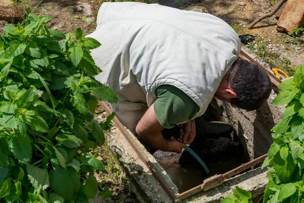 Man Manhole Releasing Water Garden Irrigation Spring Day Countryside — Stock Photo, Image