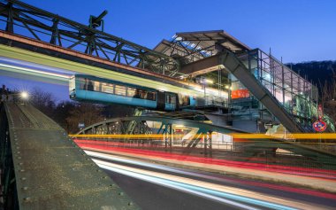 WUPPERTAL, GERMANY - JANUARY 28, 2023: Light trails around the suspension railway station Pestalozzi street in Wuppertal on January 28, 2023 in Bergisches Land, Germany clipart