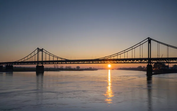 stock image Old bridge crossing the Rhine river during sunset, Krefeld, North Rhine Westphalia, Germany