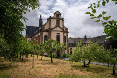 Himmerod, Germany - July 26, 2024: Panoramic image of monastery church Himmerod in morning light on July 26, 2024 in Rhineland-Palatinate, Germany clipart