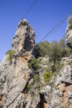 Bir ip cambazı, kanyonun üzerinde gerilmiş bir kablo boyunca yürür..