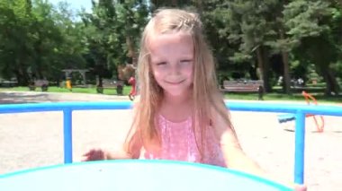 Happy Child Playing at Playground, Spinning, Kid Rotating on Merry-Go-Round, Children