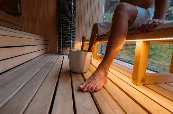 Relaxing Man Wrapped White Towel Sitting Sweating Wooden Bench Hot — Stock Photo, Image