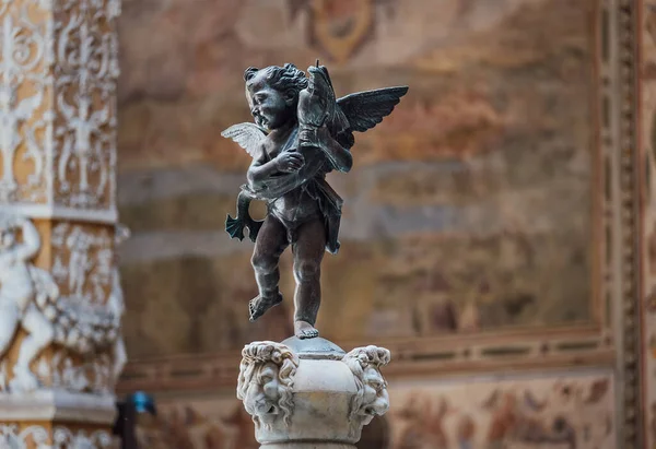 stock image Sculpture of cupid with dolphin in the inside contryyard of a Palazzo Vecchio palace in the old Florence town, Italy.