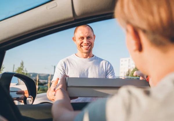 Young Sincerely Smiling Deliveryman Passing Two Pizza Boxes Female Sitting — Stock Photo, Image