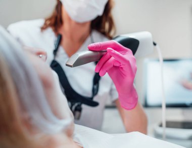 Üniformalı dişçi kadın doktor, düzgün hizalayıcı üretimi için intraoral üç boyutlu diş tarayıcı makinesi kullanıyor. Dişçi kliniğindeki hasta modern sağlık koğuşunu ziyaret ediyor. Sağlık dişleri, sağlık sektörü konsepti.