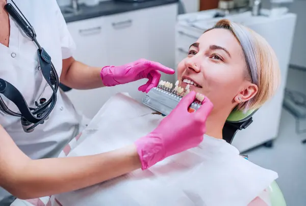 Ung Kvinna Som Sitter Kliniken Och Ler Och Visar Tänderna Stockbild