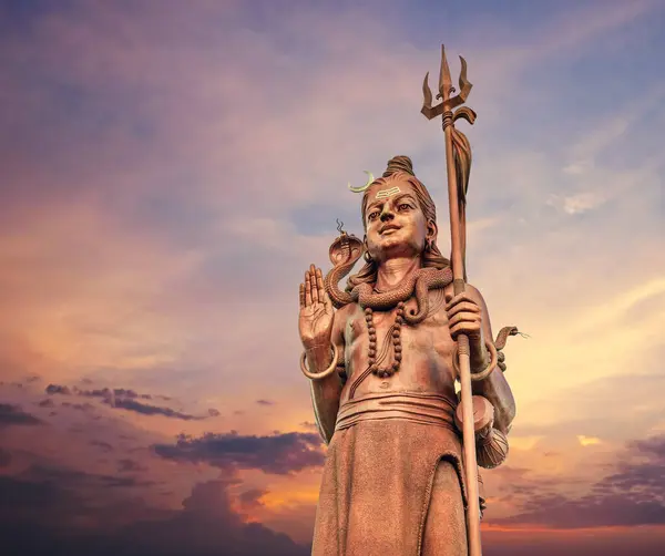 stock image The huge Shiva statue Mangal Mahadev is a 33 m art piece in Ganga talao temple on the blue evening sunset sky, Mauritius island.