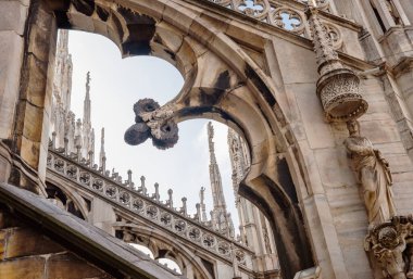 Intricate details of Duomo di Milano featuring gothic arches, statues, spires and ornate carvings. Stunning craftsmanship highlights rich history, artistic elegance of iconic architectural masterpiece clipart