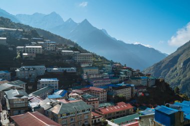 Namche Bazaar settlement on Everest Base Camp (EBC) trekking route and snowy Thamserku 6608m mountain on the background. Sagarmatha National Park, Nepal.  clipart