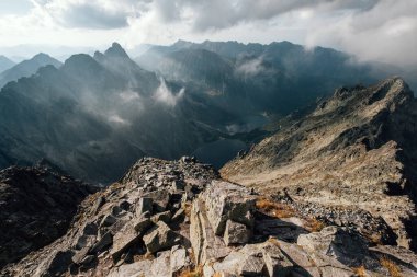 High Tatras dağlarında sabah erken saatlerde Morskie Oko gölünün üzerinde inanılmaz ışık ve gölgelerle yükselen puslu bulutlar. Rysy tepesi 2499m manzara. Morskie Gölü Oko aşağıda görünüyor..