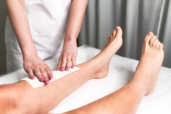 Beautician Waxing Woman Leg Applying Strip Material Hot Wax Remove — Stock Photo, Image