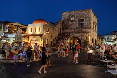 RHODES, GREECE - JULY 4, 2022: Many people in the Hippocrates square in Old town of Rhodes city in Rhodes island in Greece