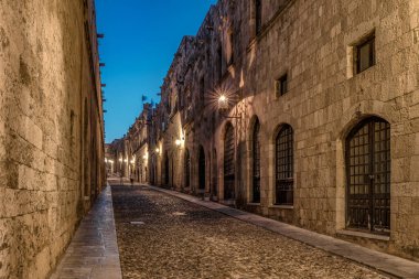 Medieval Street of the Knights called Ippoton with cobblestone road in Old town of Rhodes city at night. Rhodes island, Greece