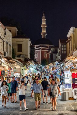 RHODES, GREECE - JULY 4, 2022: Many tourists walking through the shopping street in the old town of Rhodes city in Rhodes siland in Greece