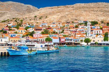 Halki, Greece - July 6, 2022: Port with fishing boats in small picturesque island Halki in Greece