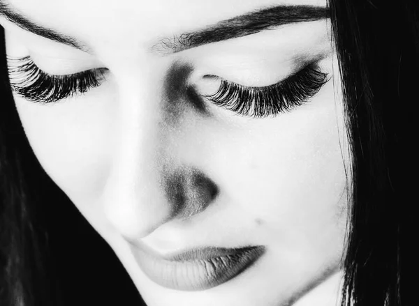 Eyelashes Makeup. Woman Beauty Face With Black Lashes Extensions. Black and white photography.