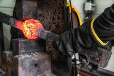 Red hot iron in the vise.