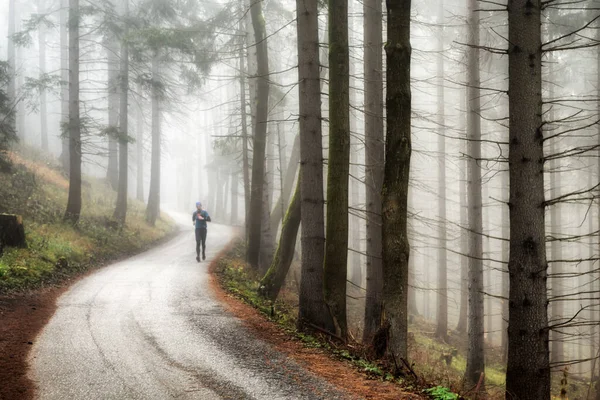 Man Running Asphalt Road Foggy Autumn Forest — Stock Photo, Image