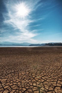 Dry and cracked earth during drought on lake Liptovska Mara in Slovakia clipart