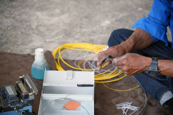 stock image Technicians sheath fiber optic cables to prepare for installation and signal testing.