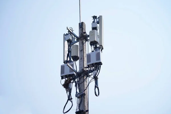 Small Cell 3G, 4G, 5G System. Macro Base Station or Base Transceiver Station on Electricity post. Wireless Communication Antenna Transmitter. Development of communication system in urban area.
