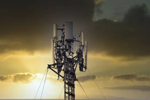 4G and 5G cellular. Macro Base Station or Base Transceiver Station. Telecommunication tower. Wireless Communication Antenna Transmitter. Development of communication systems in urban area at sunset.