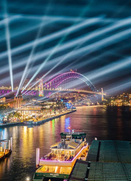 Açık köprü, rıhtım ve aydınlatılmış mimarisi olan canlı Sydney şehri, 3 Haziran, Avustralya..