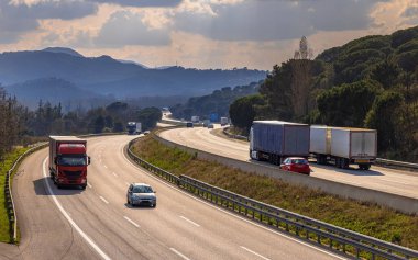 View over AP7 autoroute de Mediterrania freeway traffic with freight trucks and holiday traffic. Catalonia, Spain