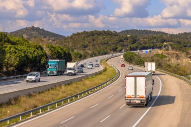 View over AP7 autoroute de Mediterrania freeway traffic with freight trucks and holiday traffic. Catalonia, Spain