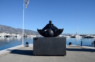 Marbella, Spain - December 10, 2023: Black sculpture of woman representing dream by artist Deredia at Banus Port, in Marbella, Spain. clipart