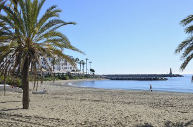 Marbella, İspanya - 10 Aralık 2023: Marbella, Endülüs, İspanya 'da güneşli bir Aralık gününde Banus plajında çok az insan.