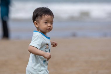 little boy have a good time at the beach