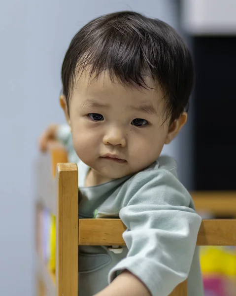 stock image Portrait image of Adorable and happy Chinese baby boy child relaxing in bed