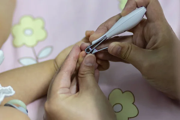 closed up shot of baby nails clipping