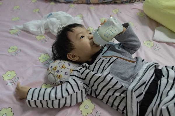 Asian Chinese Baby Boy Lying Bed Holding Milk Bottle Drinking — Stock Photo, Image
