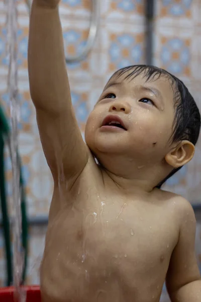 stock image adorable and happy baby boy enjoying taking bath