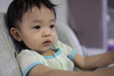 Portrait image of 1 to 2 years old childhood child. Face of relax and happy Asian boy in head shot.