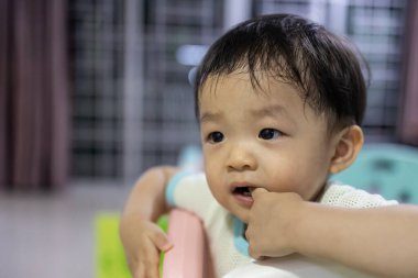 Portrait image of 1 to 2 years old childhood child. Face of relax and happy Asian boy in head shot.