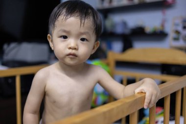 Portrait image of 1 to 2 years old childhood child. Face of relax and happy Asian boy in head shot.